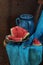 Dark blue jug and ripe water-melon on a copper dish