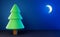 Dark blue night with moon and fir tree, simplified low poly scene, fairy tale background