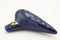 A dark blue ocarina in front of white background