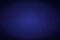 Dark blue rich horizontal background with a glow in the center. Abstract stock texture with darkened edges