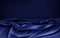 Dark blue satin fabric wavy vector background