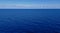 Dark blue sea with clouds and sky on the horizon