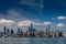 Dark blue skies fill the picture of the San Francisco skyline with a huge tower in the middle and the bay bridge crossing in front