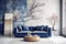 Dark blue sofa and round wooden coffee table against concrete wall with painted tree branches. Loft home interior design of modern