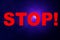 Dark blue technological background on the display and a large STOP inscription in red letters, the concept of the danger of