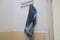 Dark blue wet towel hung on the bathroom wall