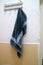 Dark blue wet towel hung on the bathroom wall