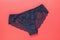 Dark blue womens panties with lace on a red background