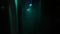 Dark blurred hospital corridor with a silhouette of a man in coverall. Stock footage. Unrecognizable person in