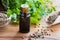 A dark bottle of coriander essential oil with coriander seeds an