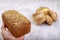 Dark bread with grains on the hand. Fresh bread in the bakery