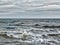 Dark brooding seascape with stormy waves and grey clouds