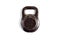 Dark brown chocolate mass in the form of a kettlebell on a white background close-up