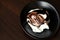 Dark brown chocolate swirl dressing on vanilla white ice cream scoop