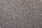 Dark brown granulated animal feed background texture