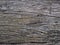 Dark brown rough old aged weathered cracked wood profile surface