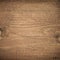 Dark brown scratched wooden cutting board. Wood