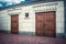 Dark brown wooden heavy doors with thick nails