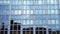 Dark building silhouette reflects in business center windows