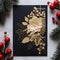 Dark card with handmade gold leaf flower and sprigs of conifers around red rowan ornament. Christmas card as a symbol of