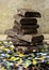 Dark chocolate almond stack, chocolate bars and block on marble background