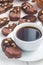 Dark chocolate biscotti cookies with almonds, covered with melted chocolate, and cup of coffee, vertical