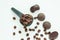 Dark chocolate candies,sweets with a spoon of coffee beans on light background. Lifestyle concept