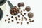 Dark chocolate candies,sweets with a spoon of coffee beans on light background. Lifestyle concept