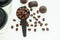 Dark chocolate candies,sweets with a spoon of coffee beans on light background. Lifestyle concept
