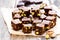 Dark chocolate cubes with pistachios on wooden background