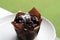 Dark chocolate muffin is sweet bakery on white dish