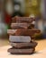 Dark chocolate. Stacked tower, stack. Seen close.  White background. Chocolate construction. Small pieces of chocolate bar. Pieces