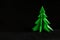 Dark Christmas and crisis concept. Christmas tree in dark black background.