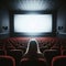 Dark cinema with audience waiting in anticipation, with black white screen