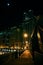 Dark city steel bridge and river promenade at night in Chicago.