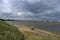 Dark clouds above Hollands Diep water with train bridges over it named Moerdijkbruggen