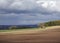 Dark clouds heralding Spring showers coming, in this view of the Strathmore Valley and derelict Cottage.