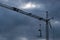 Dark clouds over a construction crane