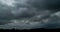 Dark clouds over mountain silhouette