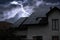 Dark cloudy sky with lightning over house. Stormy weather