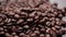 Dark coffee grains. Rotation coffee beans.