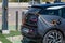Dark-coloured electric car charging its battery