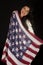 Dark complected pretty woman holding American flag scarf