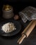 Dark composition of elements for the preparation of homemade pasta such as flour, eggs, wooden rolling pin and various accessories