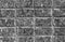 Dark concrete wall texture background with space for text. Black and white bricks wallpaper. Home interior decoration.