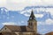 Dark contrast silhouette of church roof with tower against magnificent Alps mountains, Germany. Quiet life on fantastic peaks with