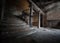 Dark creepy old basement with stone staircase leading to cellar underground light rays shining to make shadows on old stone tiled