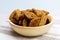 Dark croutons close-up in a wooden bowl. Close-up. Selective focus