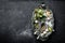 Dark culinary background with bay leaves, salt, pepper and garlic, view from above, copy space for recipe text