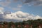 Dark cumulonimbus clouds above trees and houses to become bad weather in the Netherlands